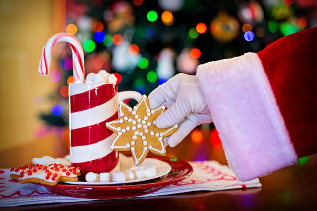 Santa's hand holding a cookie